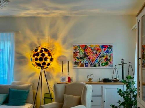 a living room with a couch and a painting on the wall at Gemütliche Zimmer - nahe am EuroVisionContest in Riehen