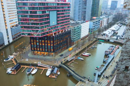 an aerial view of a city with boats in a river at De Coaster & Aquarium Ponton in Rotterdam