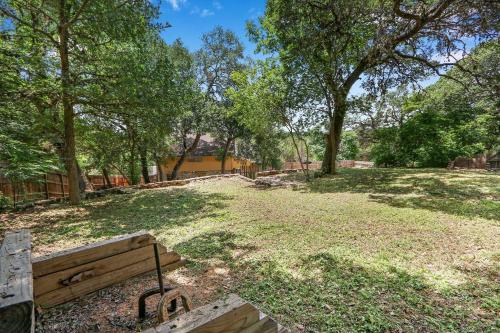 a park with a bench in a field with trees at Mi Rancho in Wimberley