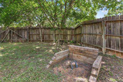 a wooden fence with a bench in a yard at Mi Rancho in Wimberley