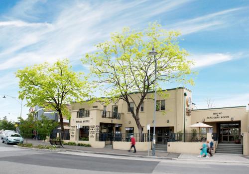 a building on a street with people walking in front of it at Royal Hotel in Springwood