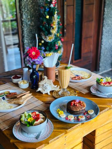 a table with plates of food and a christmas tree at La Casa Bella in Ella