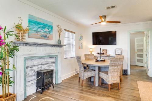 a dining room with a fireplace and a table and chairs at Less Than 1 Mi to Beach Family-Friendly Port St Joe Home in Port Saint Joe