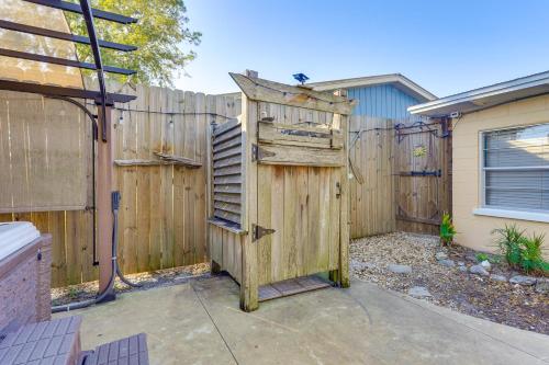a wooden bird house sitting in front of a fence at Less Than 1 Mi to Beach Family-Friendly Port St Joe Home in Port Saint Joe