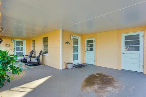 a yellow house with two chairs and two doors at Less Than 1 Mi to Beach Family-Friendly Port St Joe Home in Port Saint Joe