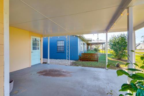 an empty patio with a blue house at Less Than 1 Mi to Beach Family-Friendly Port St Joe Home in Port Saint Joe