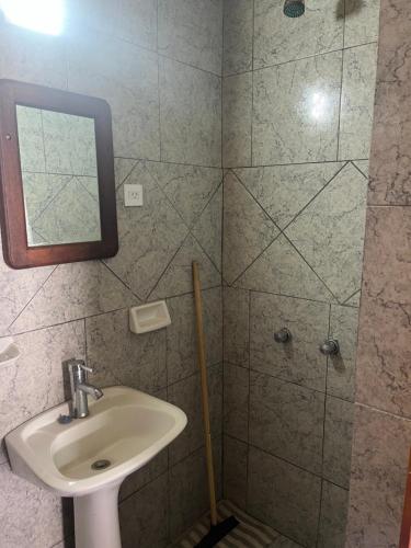 a bathroom with a sink and a shower at Don Pototo Hospedaje Chapadmalal in Colonia Chapadmalal