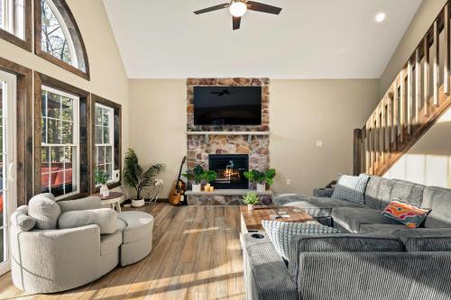 a living room with a couch and a fireplace at Lakeview Sunset Heaven Waterfront Escape Private Dock Firepit Game Room New Construction in Blakeslee