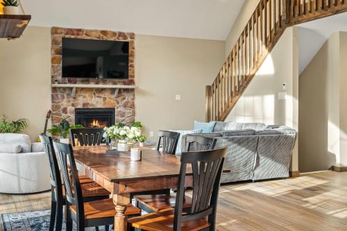 a dining room with a table and chairs and a fireplace at Lakeview Sunset Heaven Waterfront Escape Private Dock Firepit Game Room New Construction in Blakeslee
