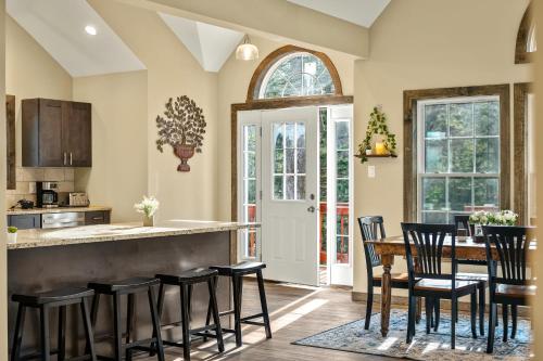 a kitchen and dining room with a table and chairs at Lakeview Sunset Heaven Waterfront Escape Private Dock Firepit Game Room New Construction in Blakeslee
