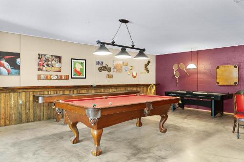 a room with a pool table and a piano at Lodge At Tellico in Tellico Plains