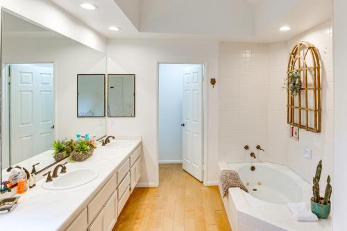 a white bathroom with two sinks and a tub at Central Condo with Water Views in Lake Arrowhead! in Lake Arrowhead