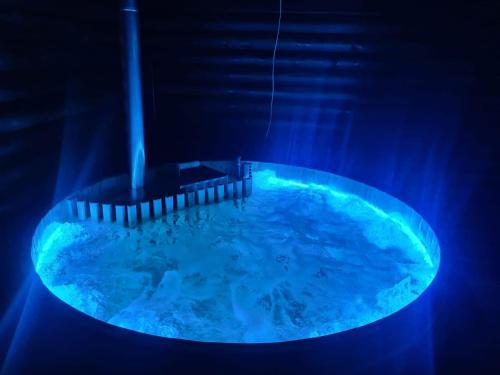 a hot tub with blue lighting in a room at Pensiunea La Ancuța-n Bucovina in Voronet