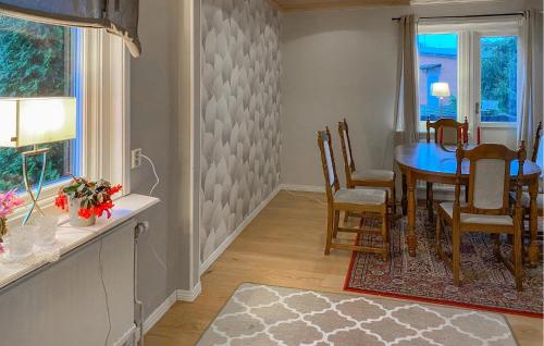 a dining room with a table and chairs at 2 Bedroom Awesome Home In Rörvik in Rörvik