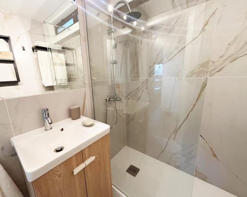 a bathroom with a shower and a sink and a toilet at Casa do Zimbro in Troia