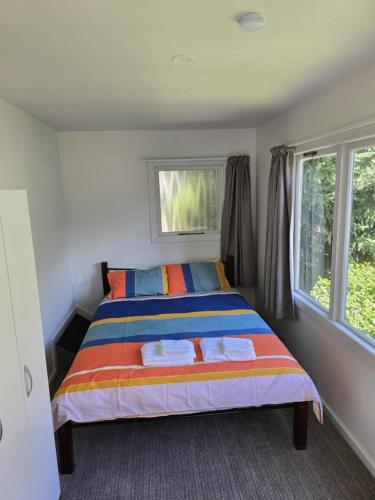 a bedroom with a bed with two towels on it at The Last Resort Hostel in Queenstown