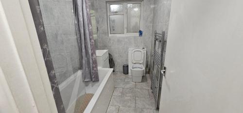 a bathroom with a toilet and a sink at Two Bedrooms Self Catering Entire House in Greater London of Dagenham in Dagenham