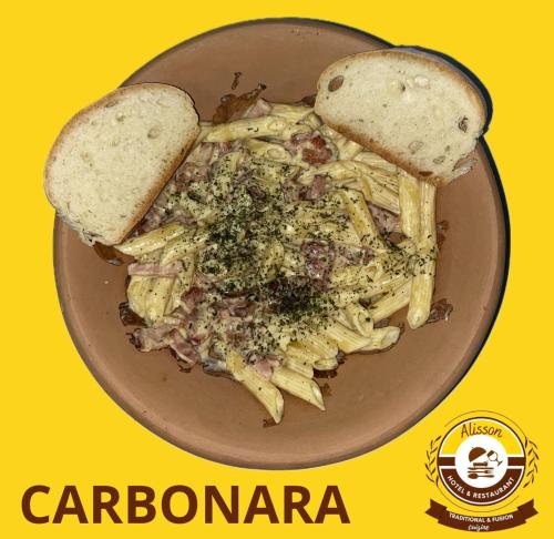 a plate of pasta with a slice of bread and a sandwich at Alisson Hotel y Restaurant in Monteverde Costa Rica