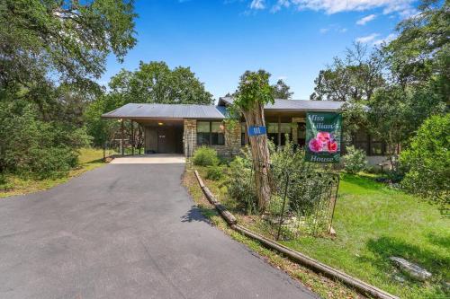 a house with a driveway in front of it at Miss Lilian's House in Wimberley