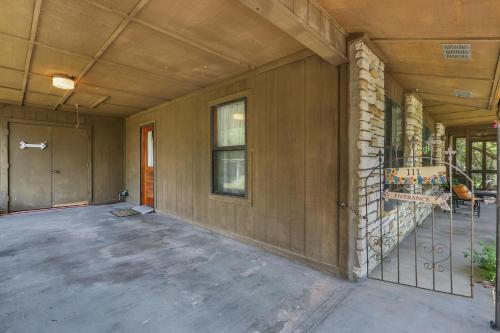 an empty house with a porch and a building at Miss Lilian's House in Wimberley