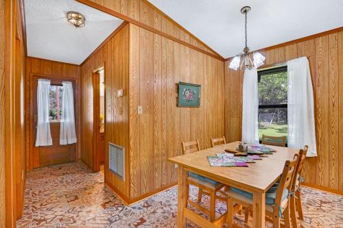 a dining room with a wooden table and chairs at Miss Lilian's House in Wimberley