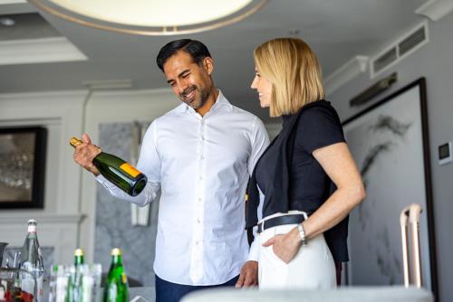 a man and a woman looking at a bottle of wine at Melrose Georgetown Hotel in Washington
