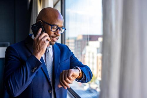 a man in a suit talking on a cell phone at Melrose Georgetown Hotel in Washington