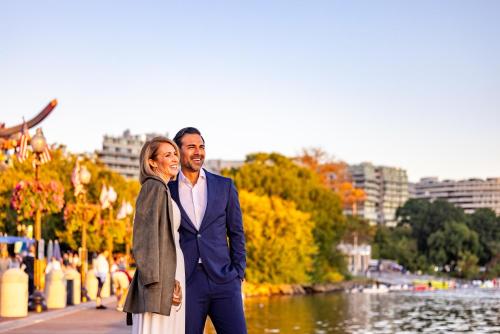 a man and a woman standing next to a river at Melrose Georgetown Hotel in Washington