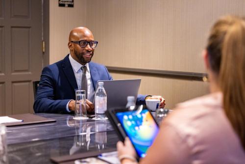 a man in a suit sitting at a table with a woman at Melrose Georgetown Hotel in Washington
