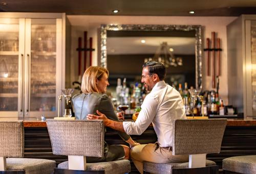 a man and a woman sitting at a bar at Melrose Georgetown Hotel in Washington
