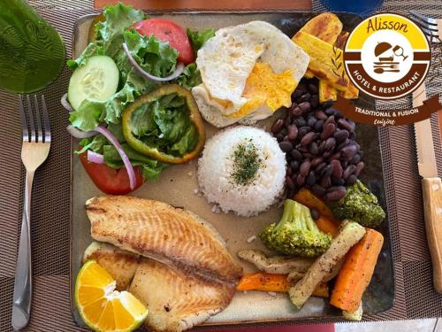 a plate of food with fish rice beans and vegetables at Alisson Hotel y Restaurant in Monteverde Costa Rica