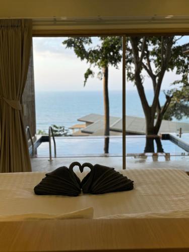 a pair of gloves in the shape of a heart on a bed at High Life Villas in Salad Beach