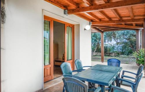 eine Terrasse mit einem blauen Tisch und Stühlen in der Unterkunft Awesome Home In Santa Maria Del Focall in Santa Maria Del Focallo