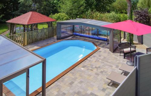 a swimming pool with an umbrella and a gazebo at Pet Friendly Home In Blessy in Blessy