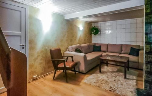 a living room with a couch and a table at Gorgeous Home In Skollenborg in Kongsberg