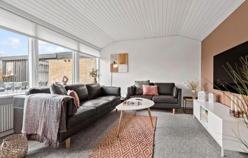 a living room with a couch and a table at 2 Bedroom Stunning Home In Grenaa in Grenå