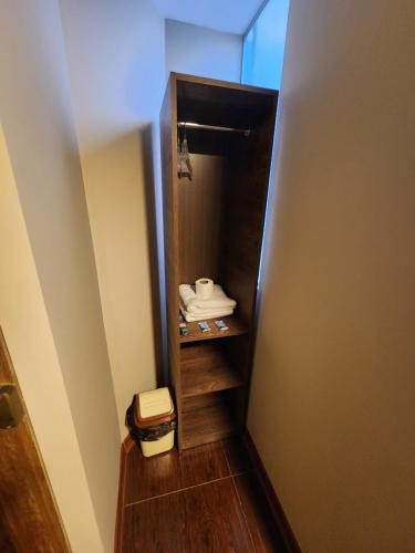 a room with a closet with someones shoes in it at Hospedaje Casa Huayra in Cusco
