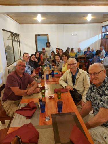 a group of people sitting around a long table at Alisson Hotel y Restaurant in Monteverde Costa Rica