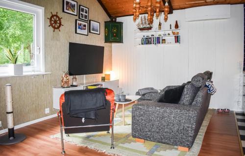 a living room with a couch and a table at 3 Bedroom Amazing Home In Ronneby in Ronneby