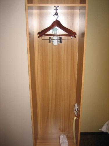a wooden door with a light hanging from it at HOTEL CITY INN WAKAYAMA Wakayama-Ekimae in Wakayama