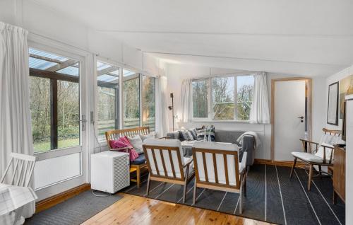 a living room with a table and chairs at Awesome Home In Martofte With Wifi in Martofte