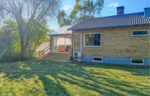 a brick house with a large yard in front of it at 4 Bedroom Nice Home In Färjestaden in Färjestaden