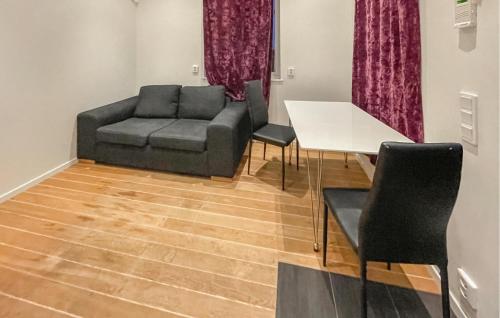 a living room with a couch and a table at Gorgeous Home In Landvetter in Landvetter