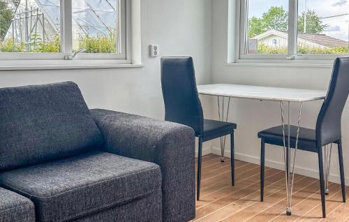 a living room with a couch and a table and chairs at Gorgeous Home In Landvetter in Landvetter