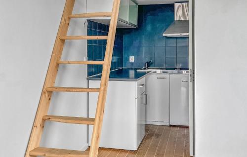 a ladder in a kitchen with a sink and a refrigerator at Gorgeous Home In Landvetter in Landvetter