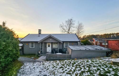 a house with snow on the ground in front of it at Amazing Home In Spydeberg With Wifi in Spydeberg