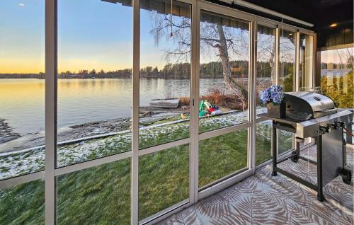 a view of a lake from a room with large windows at Amazing Home In Spydeberg With Wifi in Spydeberg