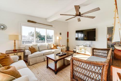 a living room with a couch and a table at Canal-Front Home with Dock in Little Egg Harbor! in Little Egg Harbor Township