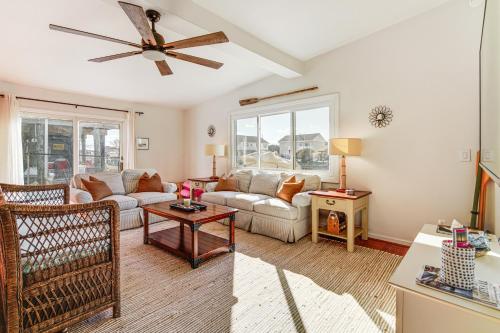 a living room with a couch and a ceiling fan at Canal-Front Home with Dock in Little Egg Harbor! in Little Egg Harbor Township