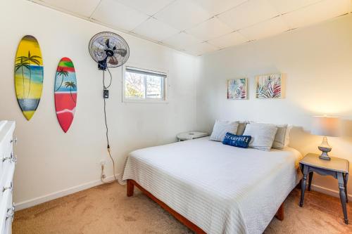 a bedroom with a bed and surfboards on the wall at Canal-Front Home with Dock in Little Egg Harbor! in Little Egg Harbor Township